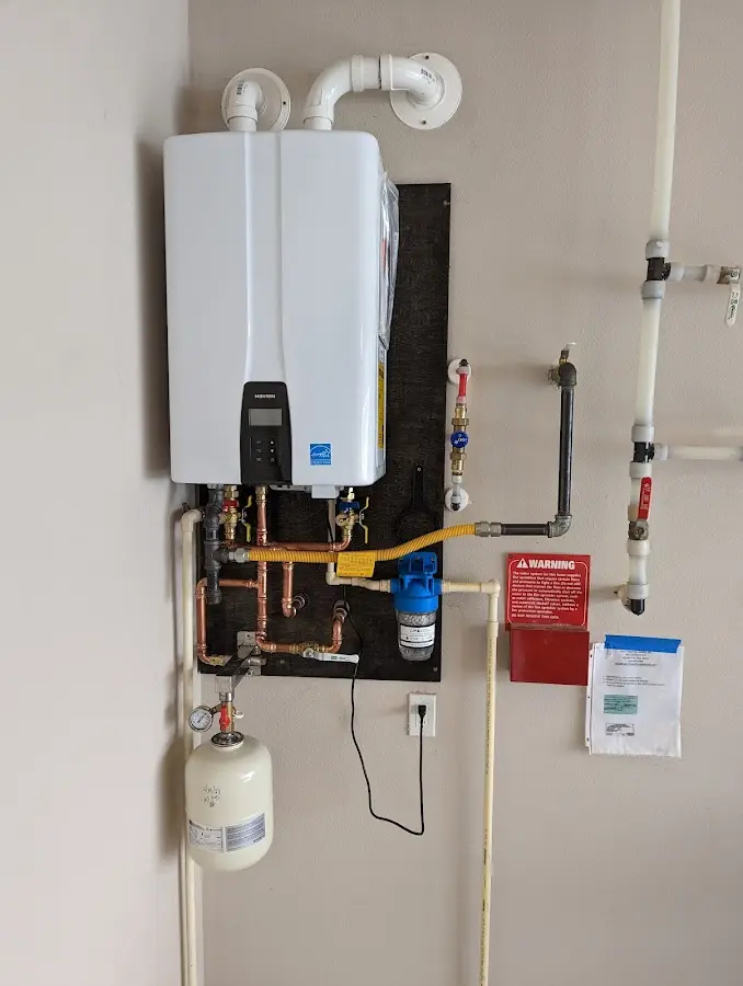 Professional plumber installing copper piping in a Willistown home